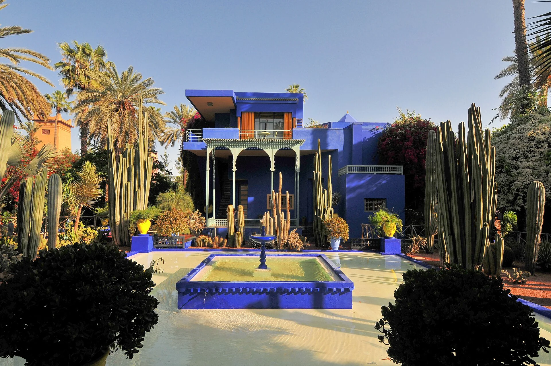 Blue architecture and lush palms at Jardin Majorelle in Marrakech